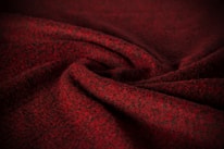Close-up of rich fabric textures in deep burgundy and soft beige, reflecting Nai & Naz’s signature colors.