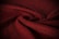 A close-up of a beautifully draped luxurious fabric in soft, rich colors.