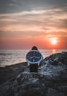round silver-colored watch on rack during sunset