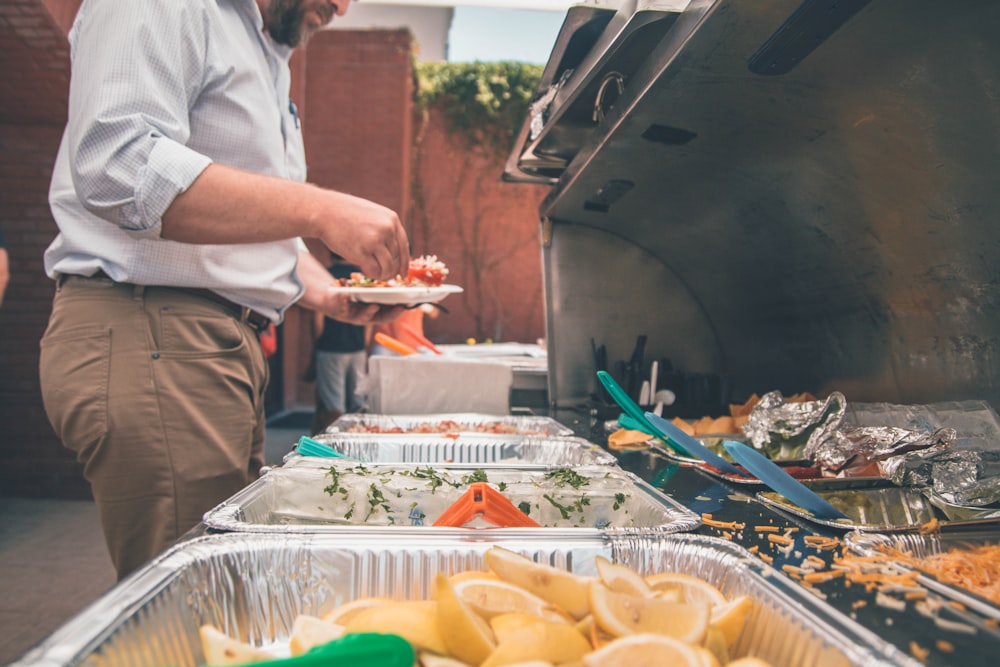 man picking foods on trays