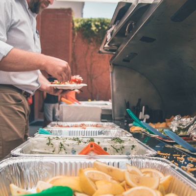 man picking foods on trays