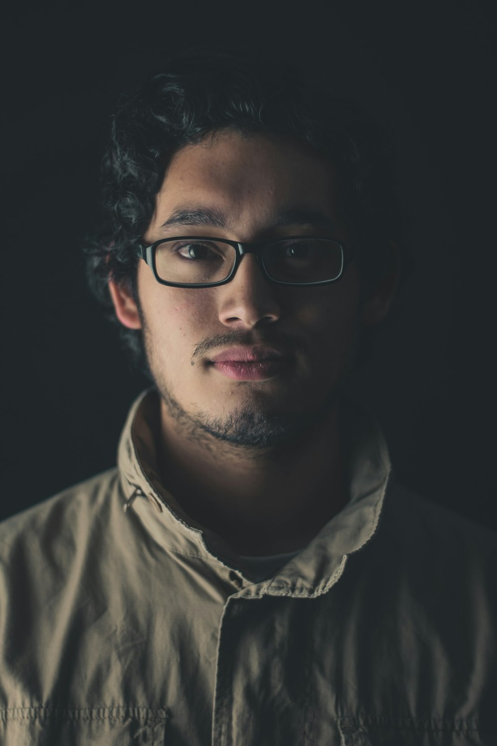 man wearing eyeglasses and brown jacket