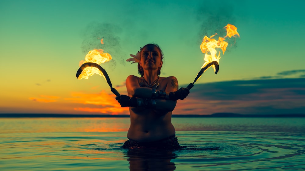 woman holding sickles with fire