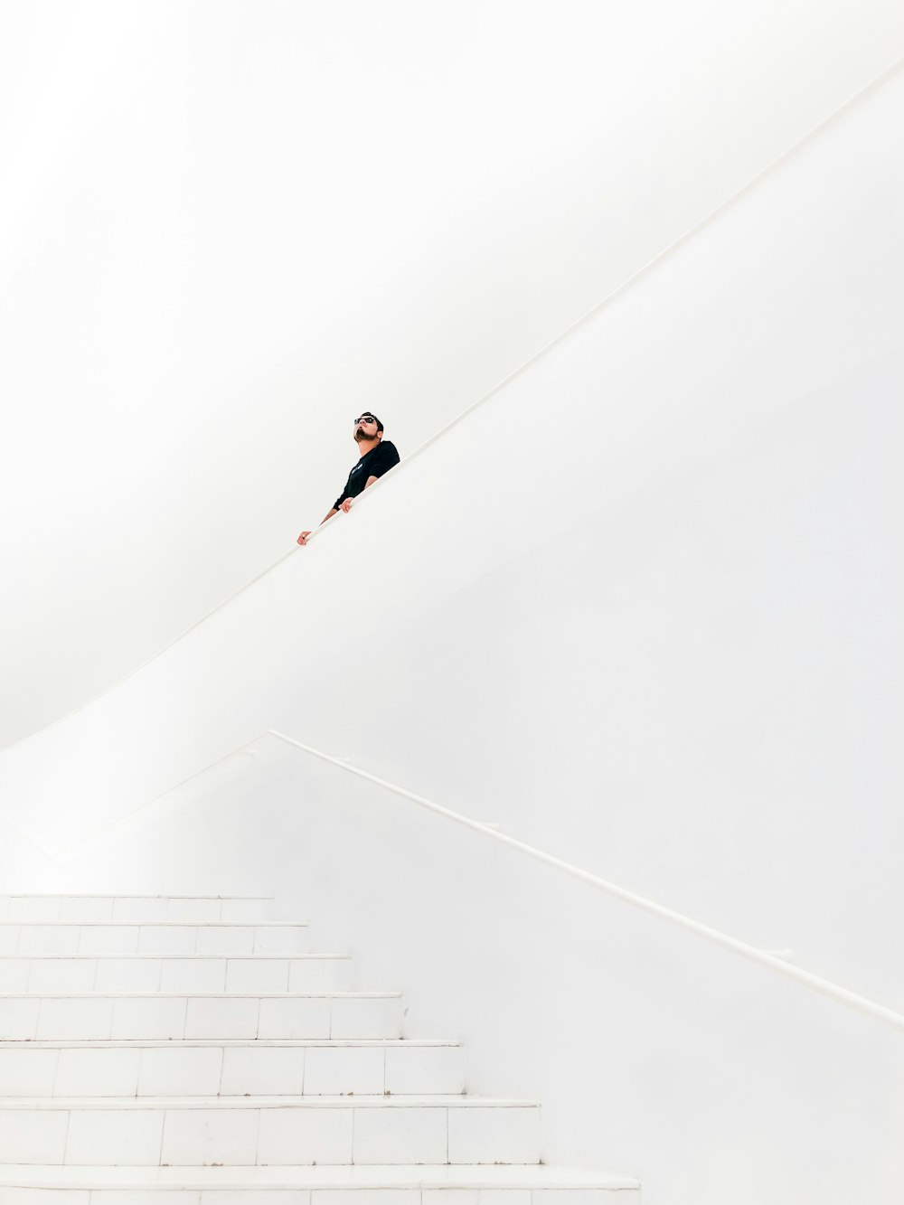 man looking up near stairs