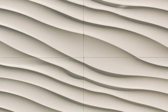 Close-up of a painter applying textured wall design in a cozy room.