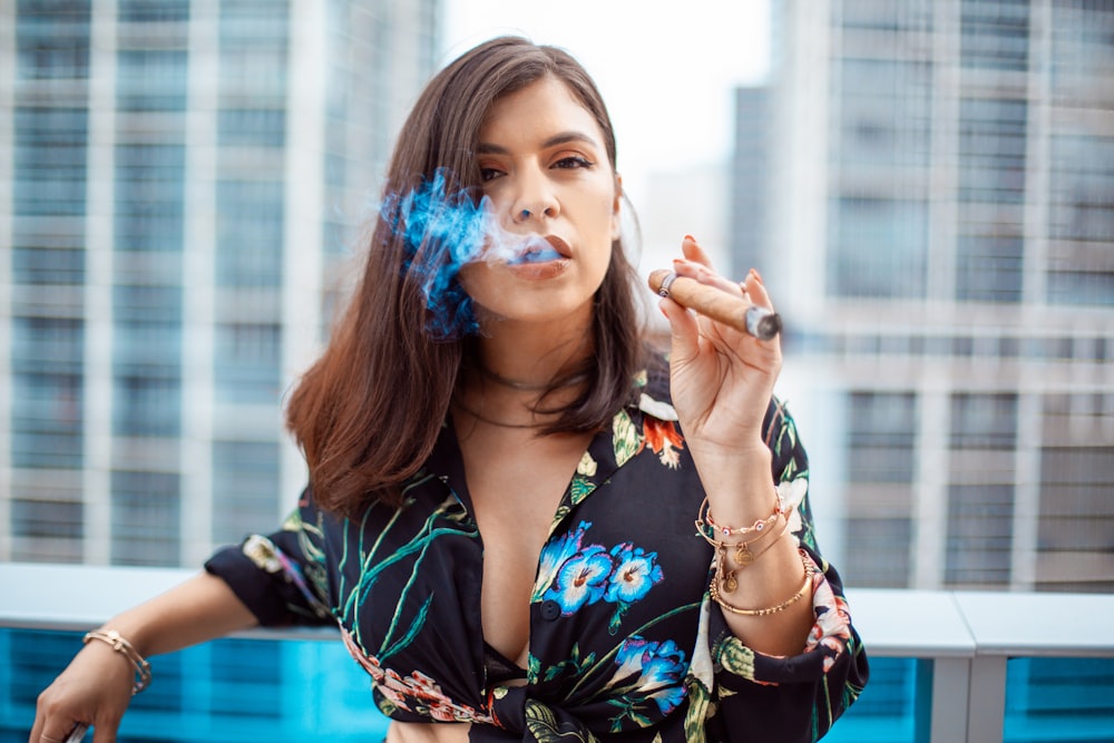 woman smoking cigar during daytime