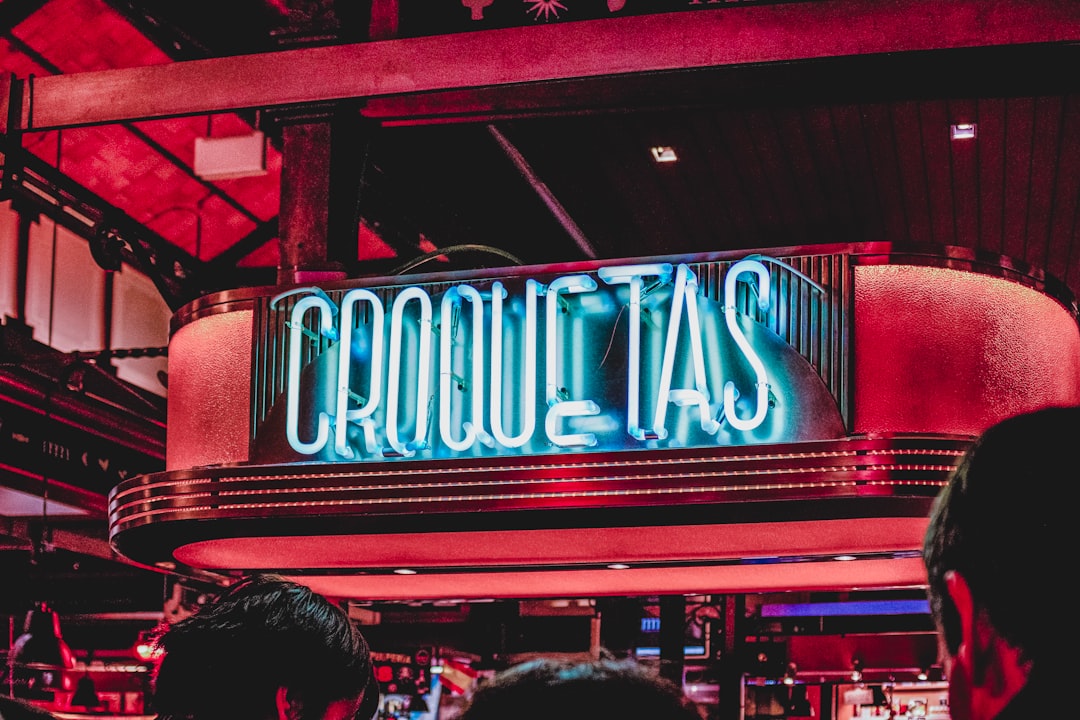group of people gather outside bar, Croquetas - Mercado San Miguel