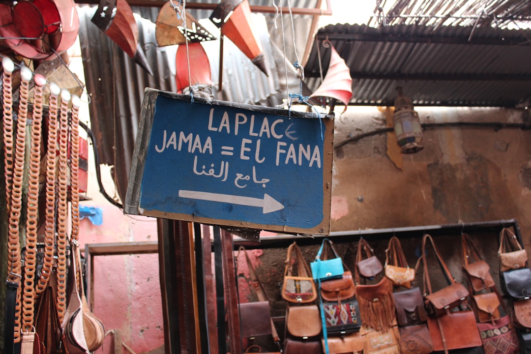 blue and brown wooden signage on black steel frame, Souk route at Marrakesh