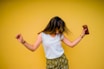 woman standing near yellow wall