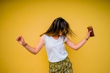 woman standing near yellow wall