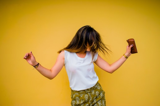 woman standing near yellow wall