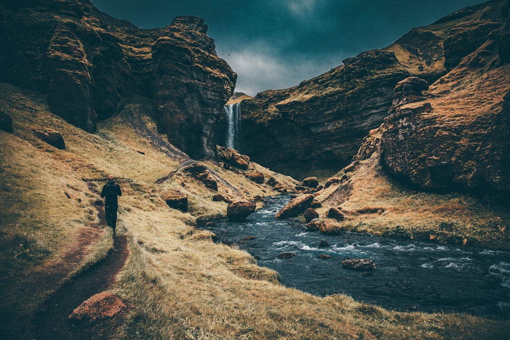 waterfalls surrounded by rock formation