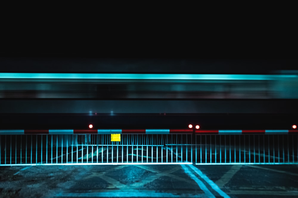 a parking lot with a fence and a yellow sign