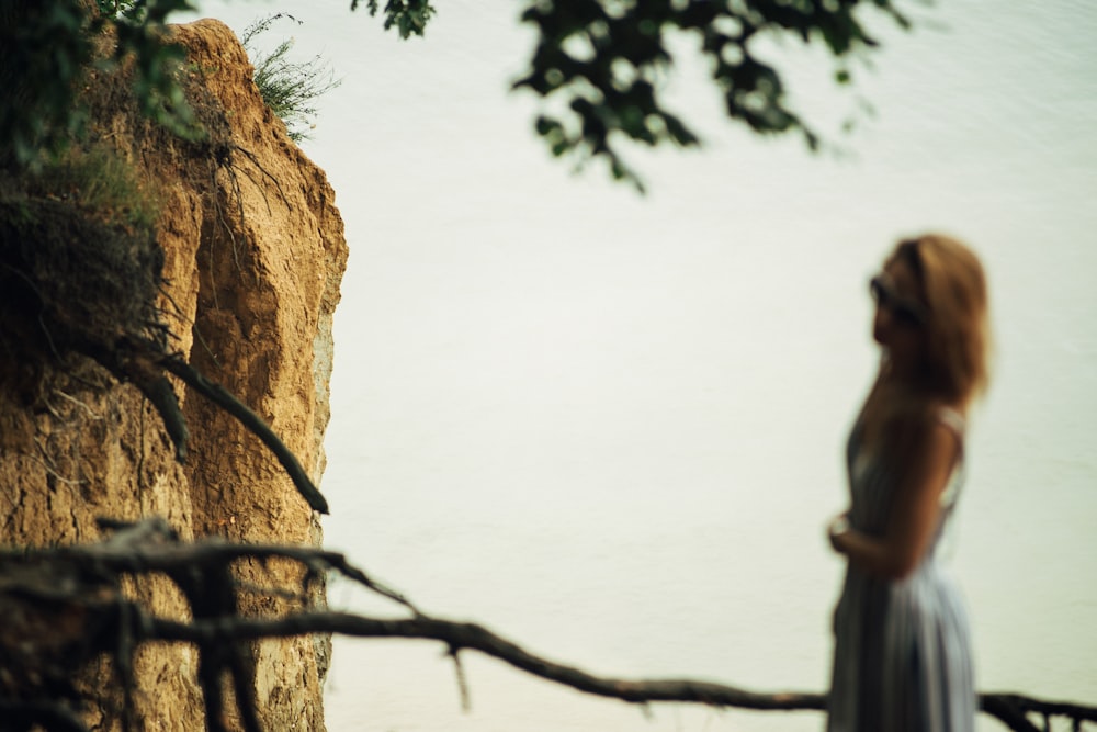 woman fronting cliff mountain