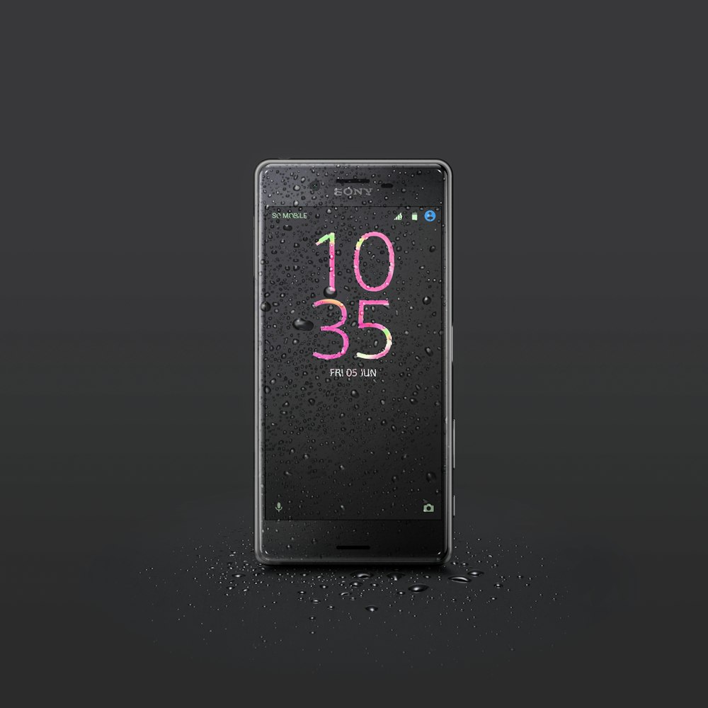 black Sony Android smartphone with water drops