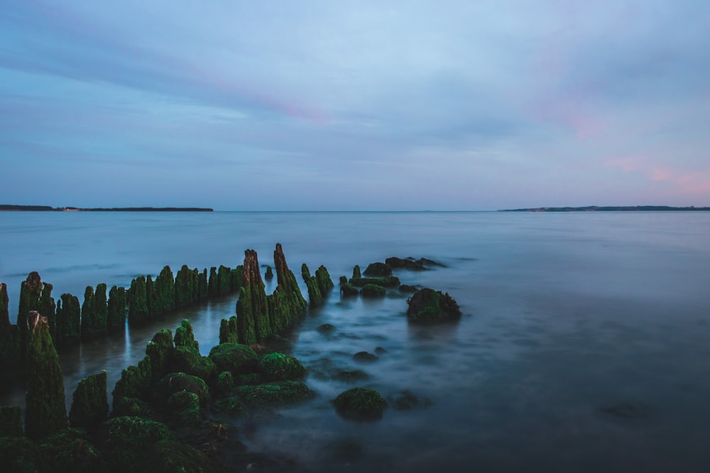 calm body of water with rocks