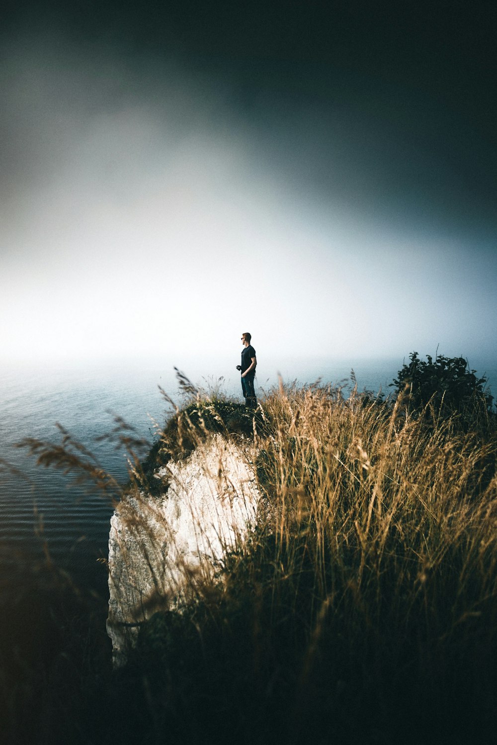 man standing on cliff