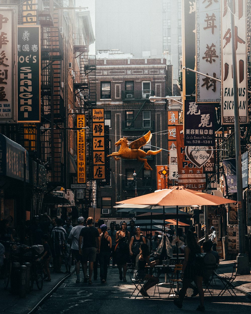 group of people walking between buildings