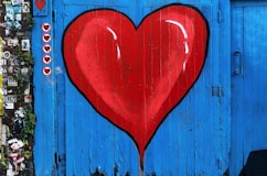 blue wooden gate with a red heart painted on it