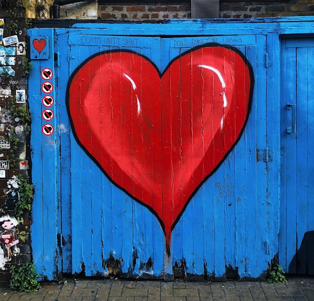 blue wooden gate with a red heart painted on it