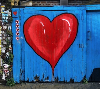 blue wooden gate with a red heart painted on it