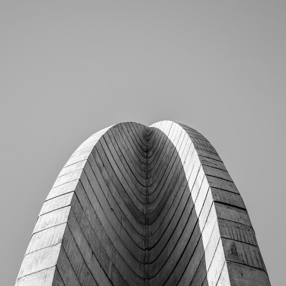 a black and white photo of a curved building