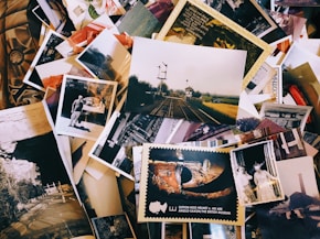 a pile of old photos and postcards sitting on top of each other