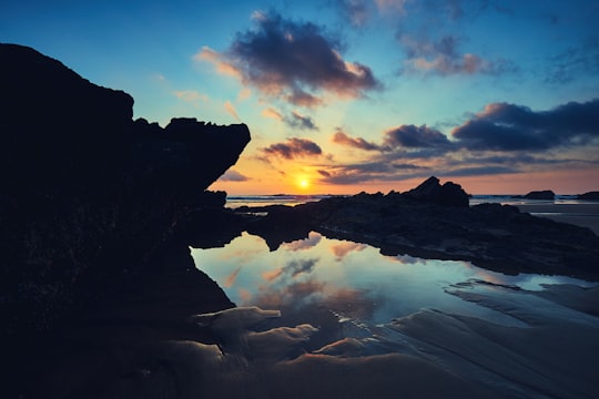 silhouette of rock island during golden hour in Barrika Spain