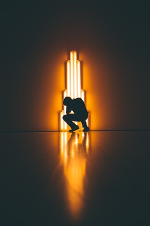 silhouette of man crouching