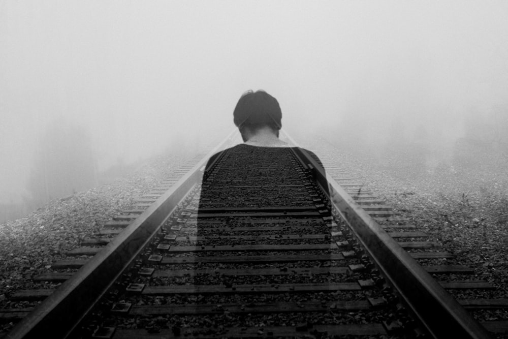 grayscale photo of man wearing black shirt