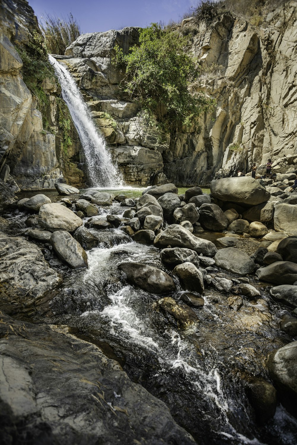 waterfalls surrounded by rock formation