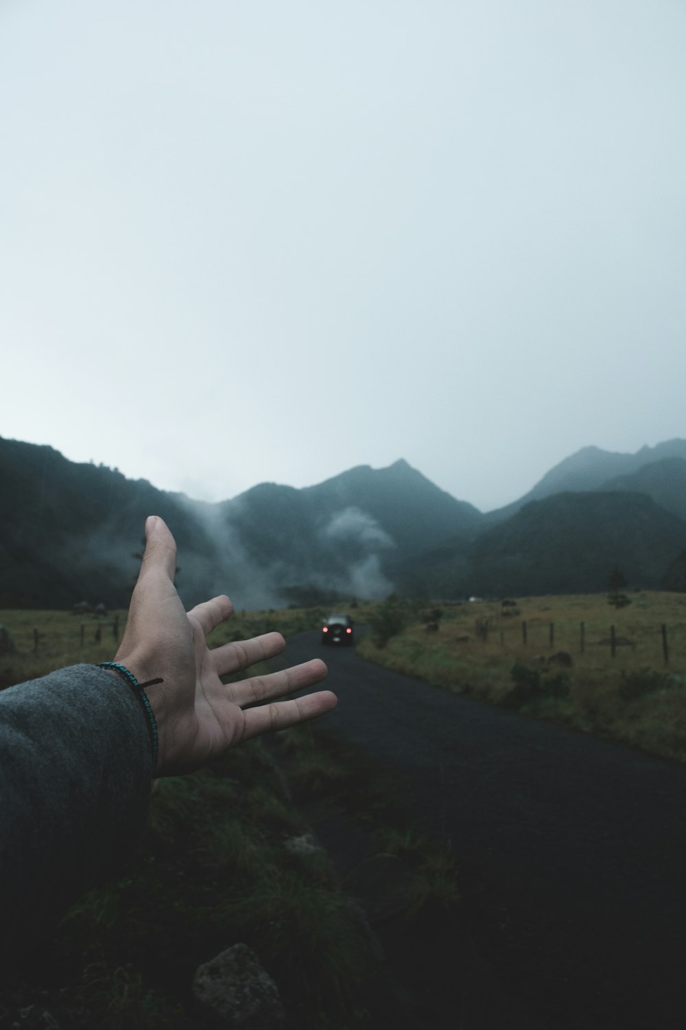 person showing black car on road