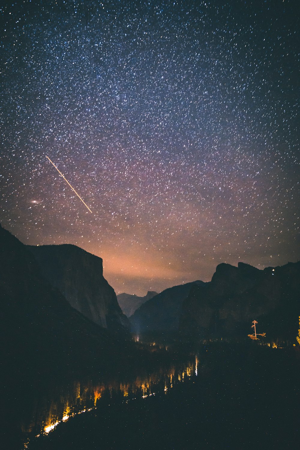 shooting star above mountains