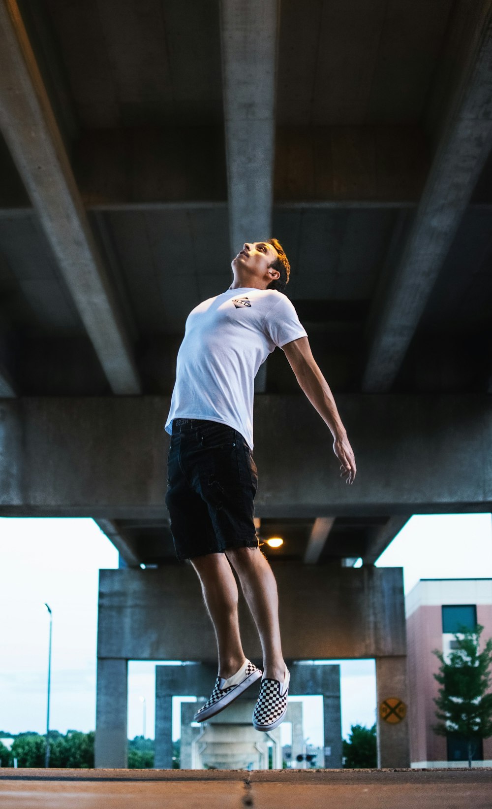 man jumping on the middle of the road