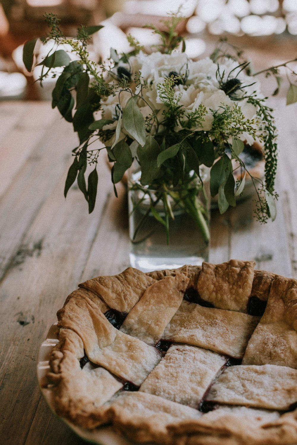 selective focus photography of baked bread beside white petaled flower