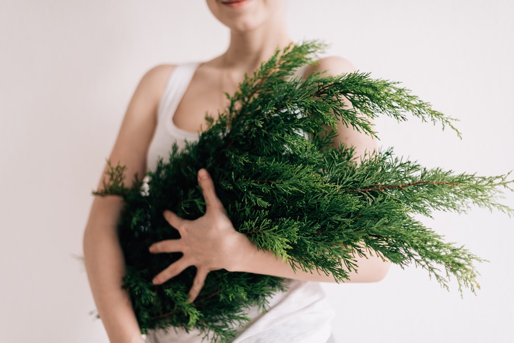 woman holding green leafs