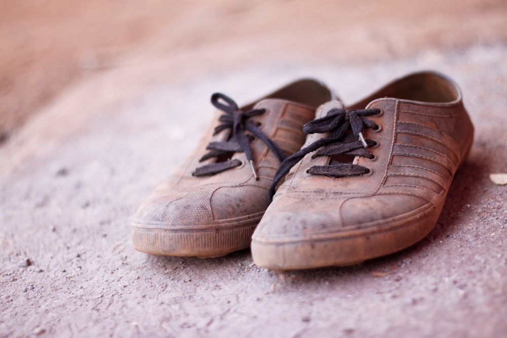 focus photography of pair of brown low-top lace-up sneaker