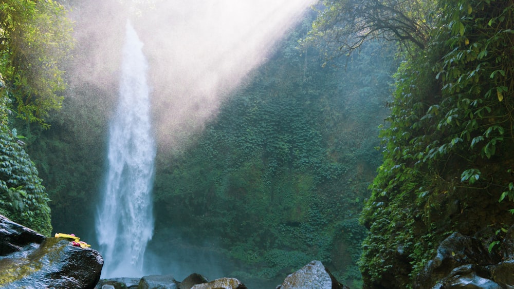 sunlight passing through waterfall during daytime