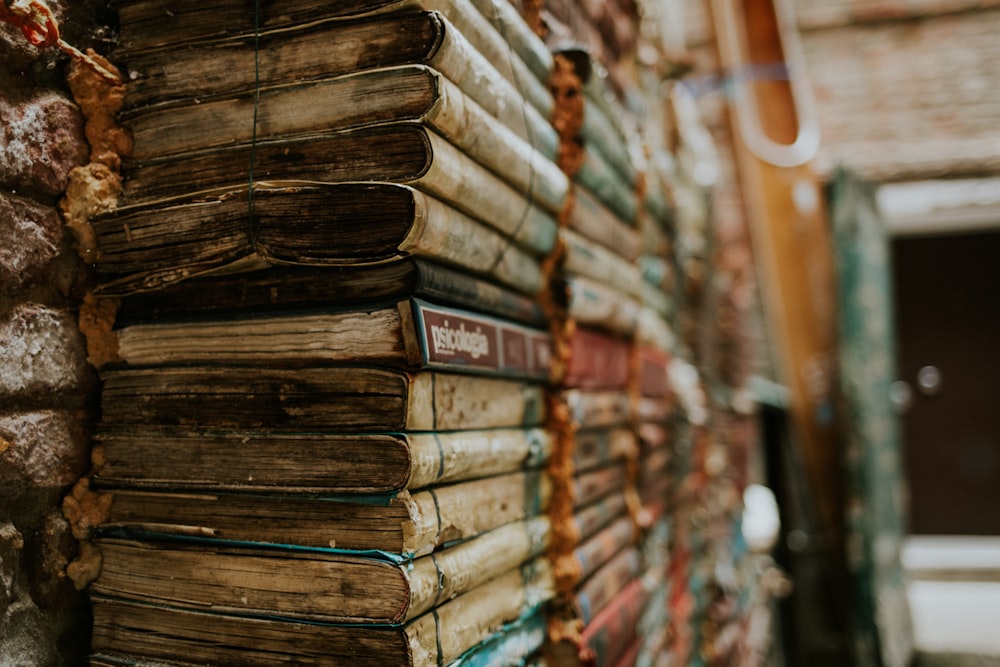 a stack of books sitting next to a building