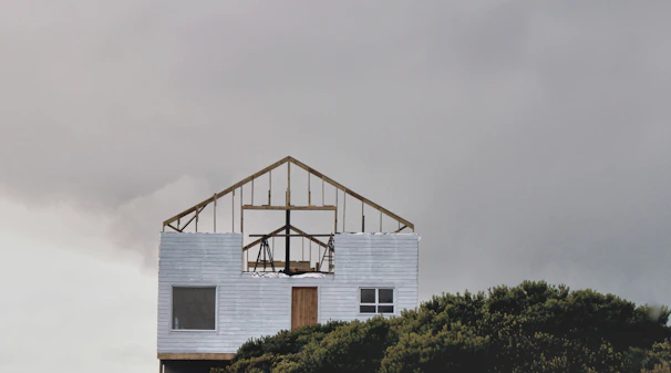 Close-up of a freshly built wood-framed home addition integrating with the original siding.