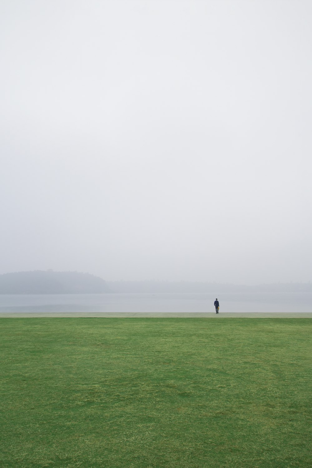 person standing near open field