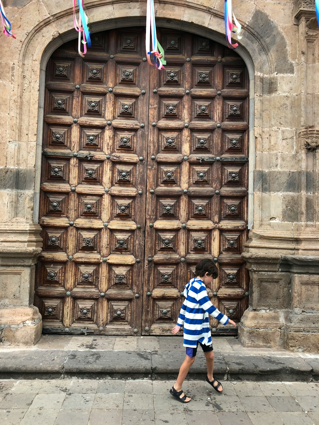 My son happily walking past some beautiful doors in Garachico, Tenerife.
