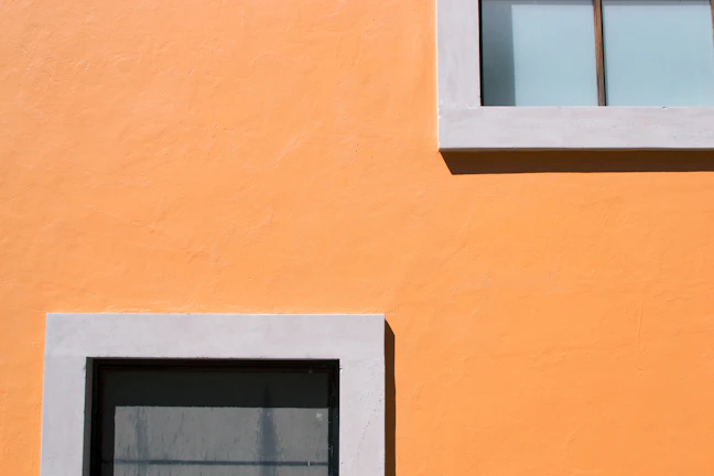 Bright orange accent wall in a modern bathroom renovation.