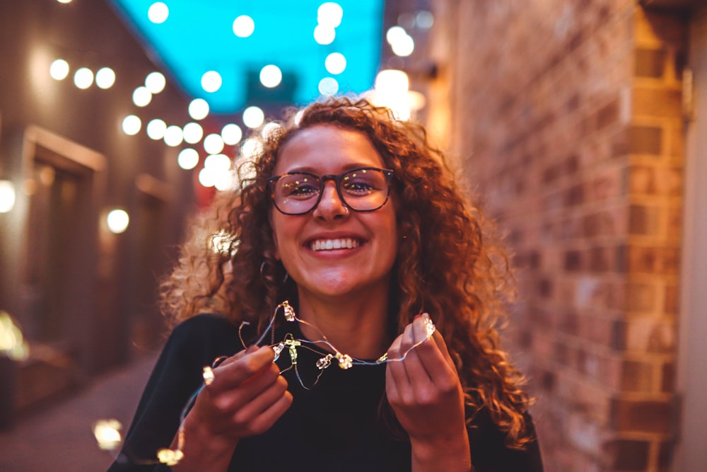 woman standing near brick wall