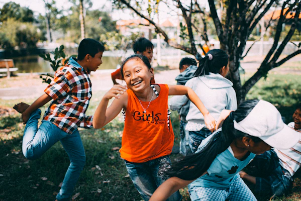 Young girl running and laughing outdoors