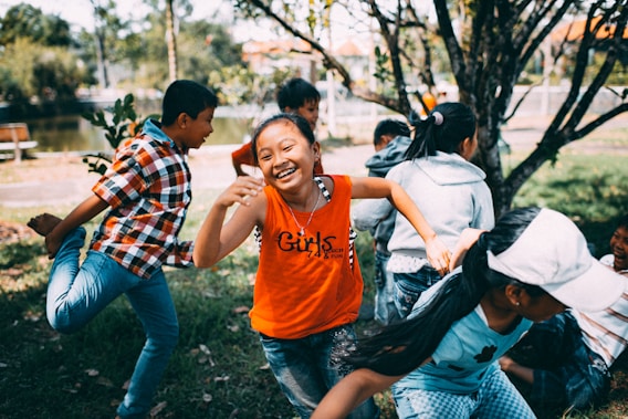 girl running while laughing with her friends actively engaged in a playful game