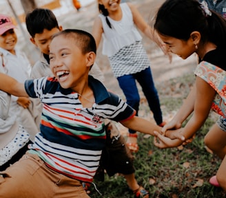 children playing on grass field