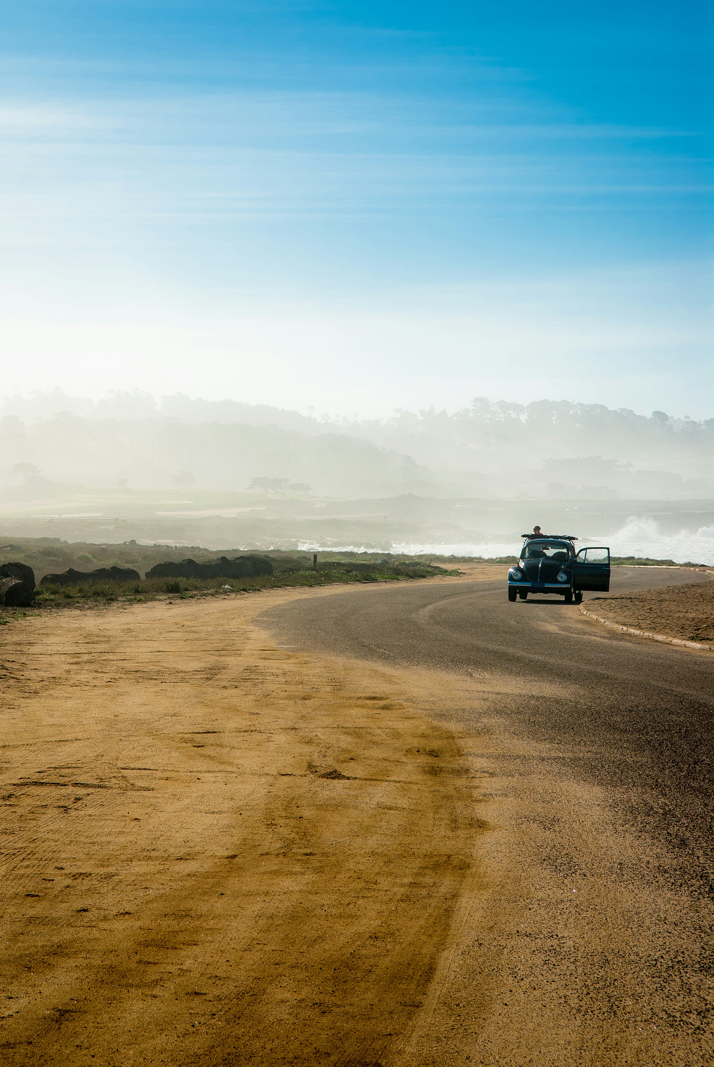 black Volkswagen Beetle on road