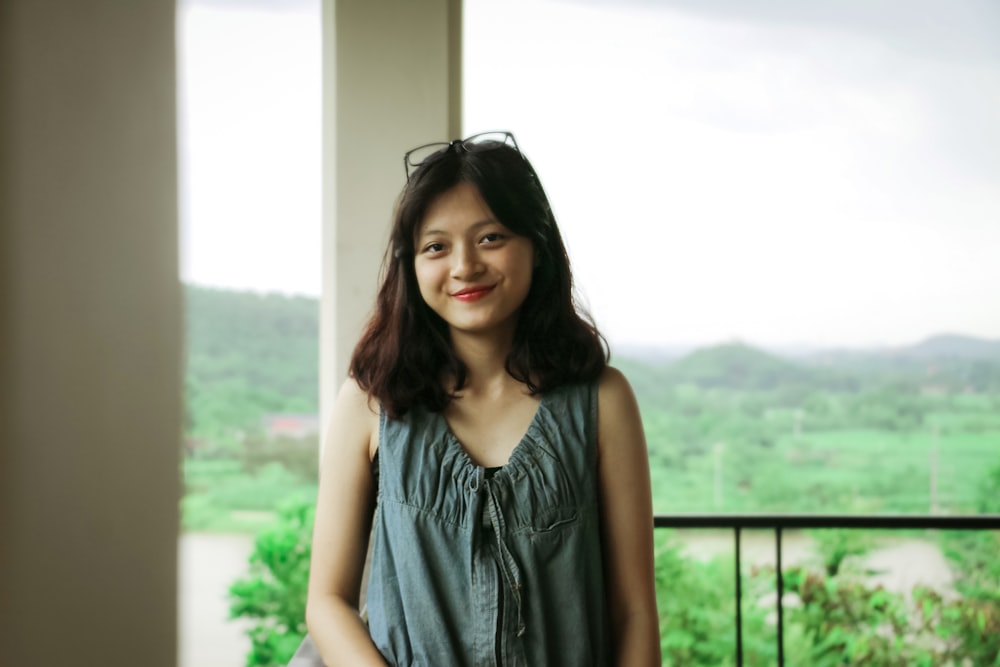 woman standing beside black fence