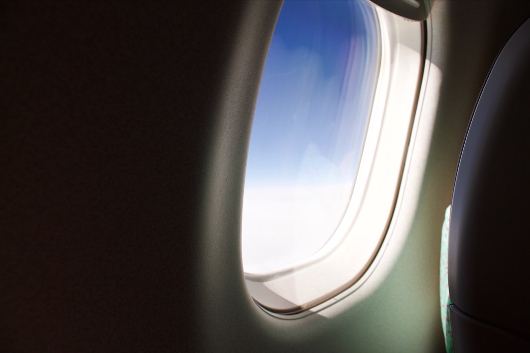 airplane window showing blue sky